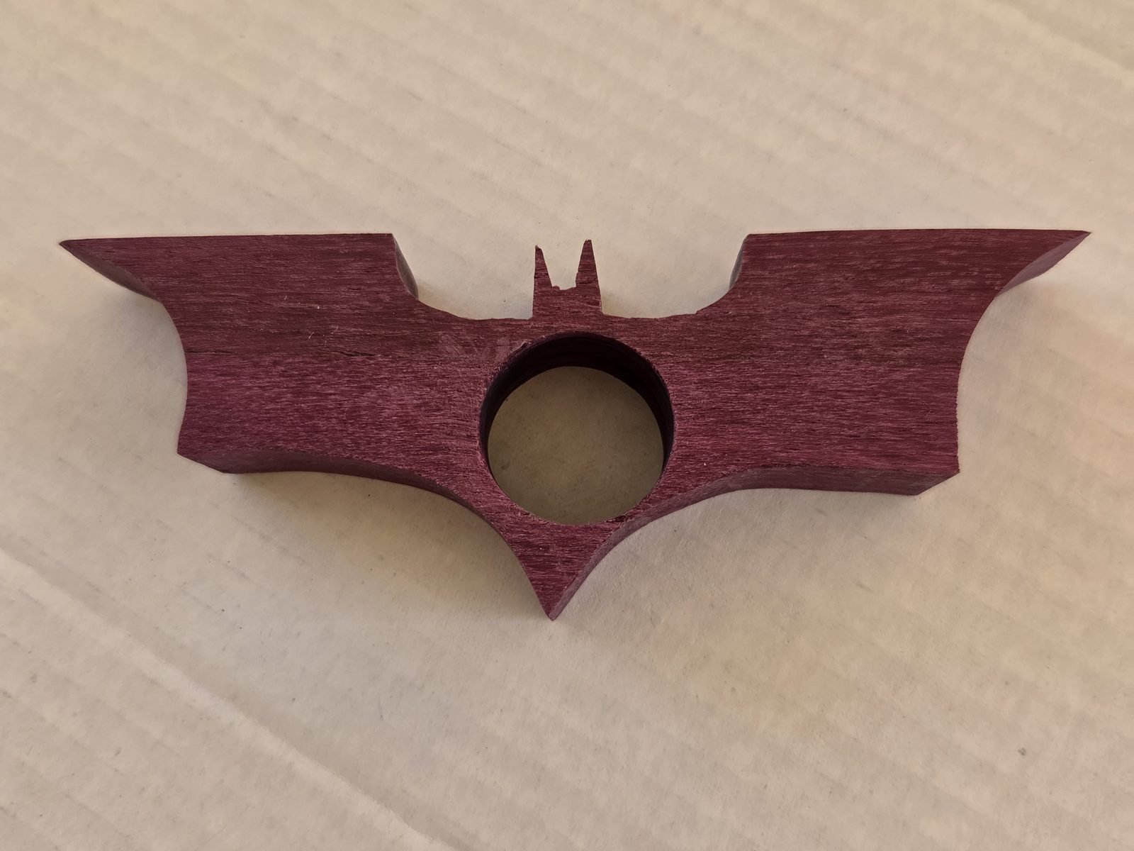 Bat thumb book holder in purpleheart, handmade by Gilbert